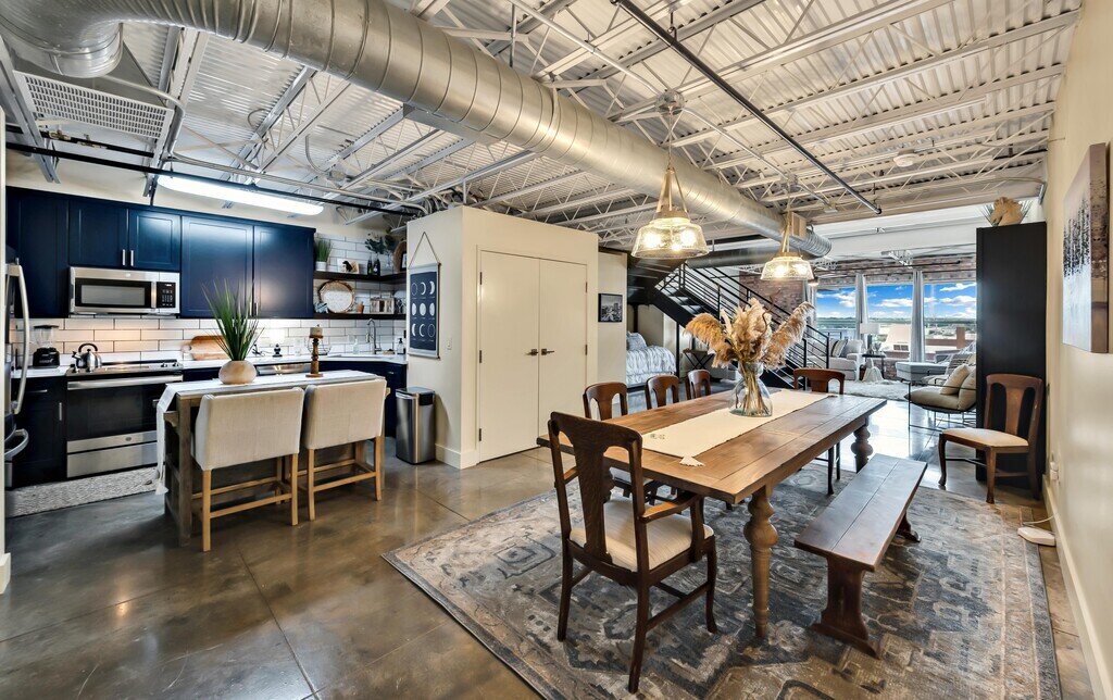 Fully stocked kitchen that opens up to beautiful dining area that seats eight in this 2 bedroom, 2.5 bathroom luxury vacation rental loft condo for 8 guests with incredible downtown views, free parking, free wifi and professional decor in downtown Waco, TX.