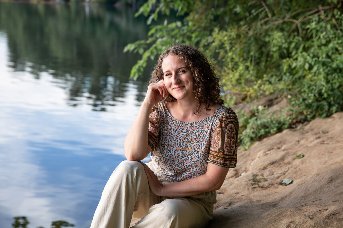 A solopreneur smiles during her natural, outdoors personal branding photos.