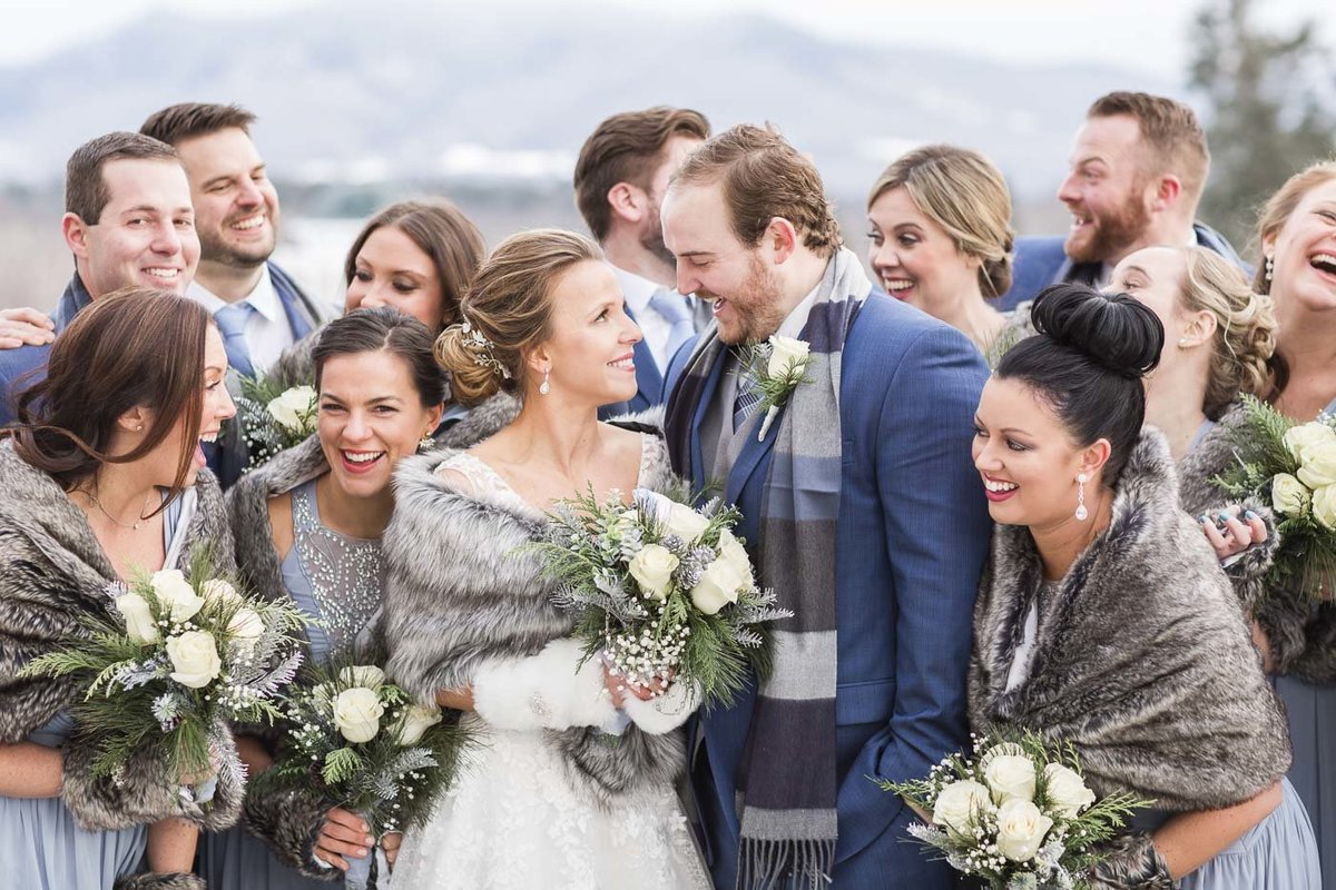 Bride, Groom, and their wedding party at their winter wedding