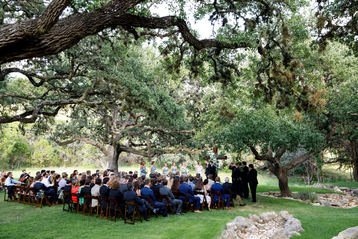ivory oak austin wedding photographer 1521 Unit B Deer Lake Rd, Wimberley, TX 78676 ceremony under trees