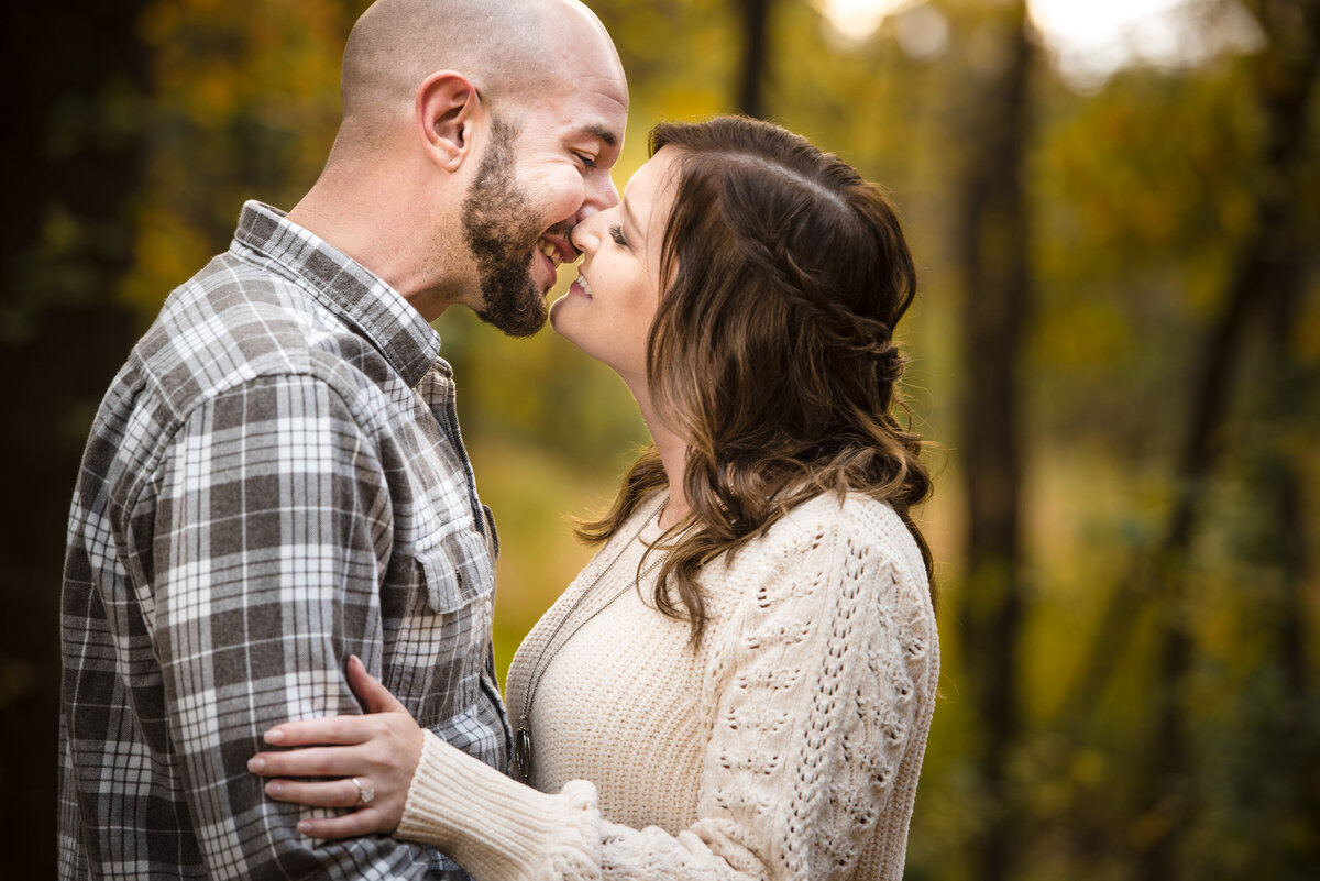 Engaged-couple-smiling-just-before-a-kiss-in-fall-clothing-at-Latta-Plantation