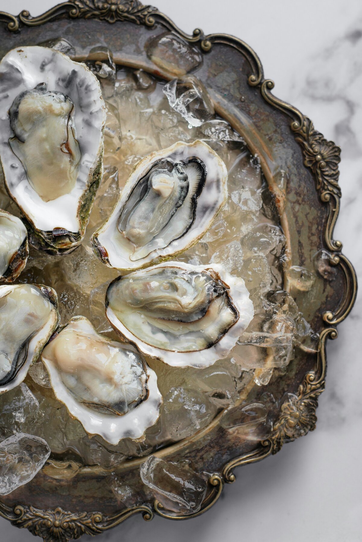 oysters on ice on brass platter