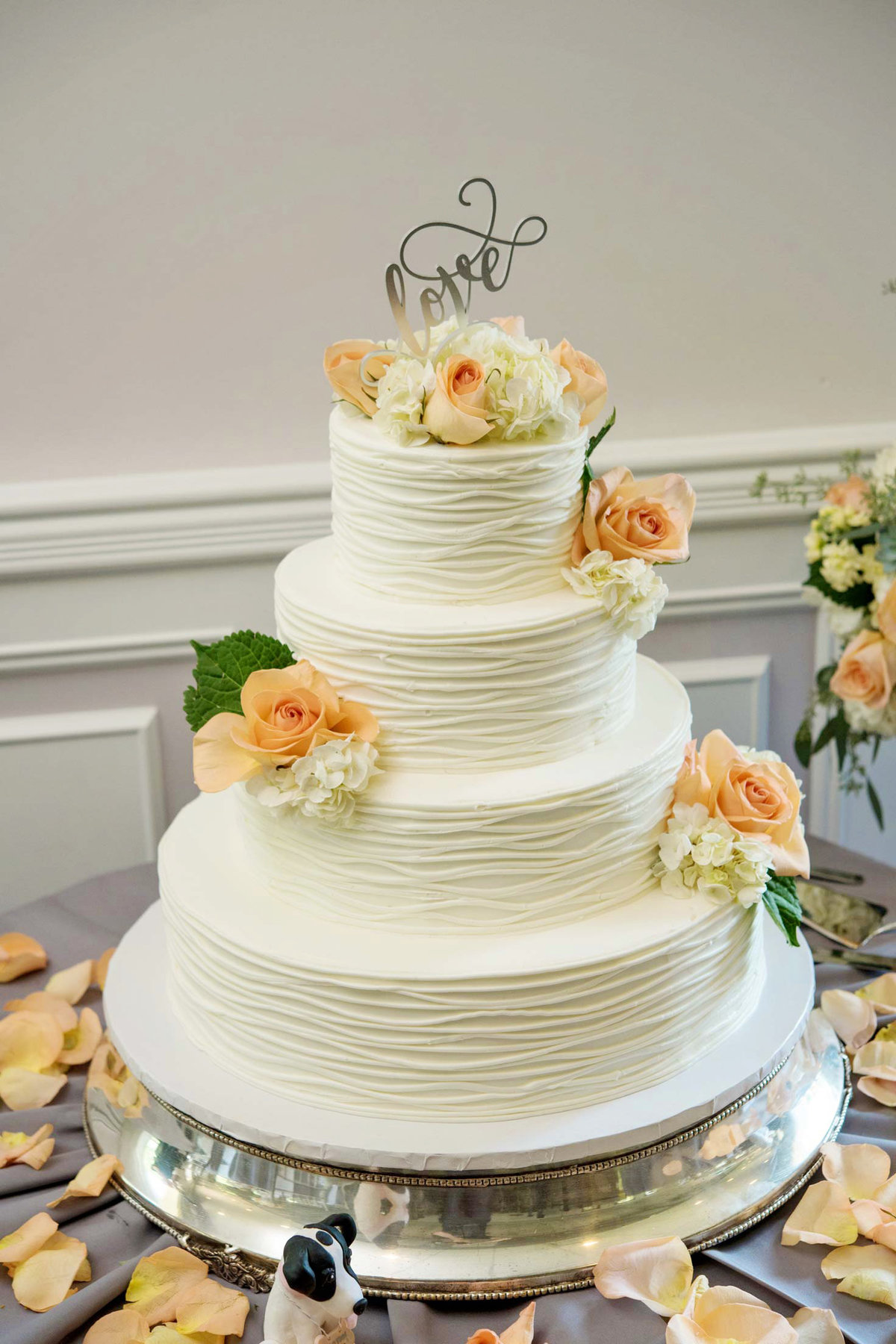 White wedding cake with flowers at Flowerfield