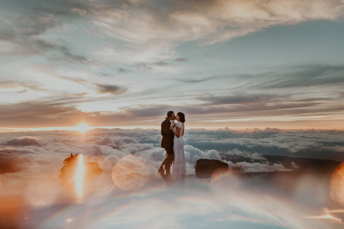 Picture of bride hugging groom on top of a mountain in Maui