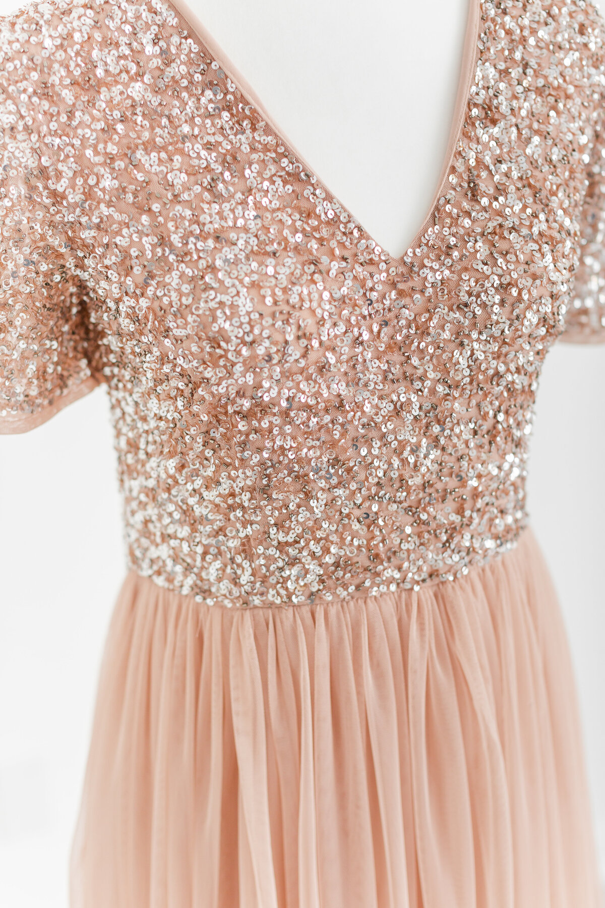 A closeup photo of a pink tulle dress with a sequin bodice for your Nova Studio Photography session