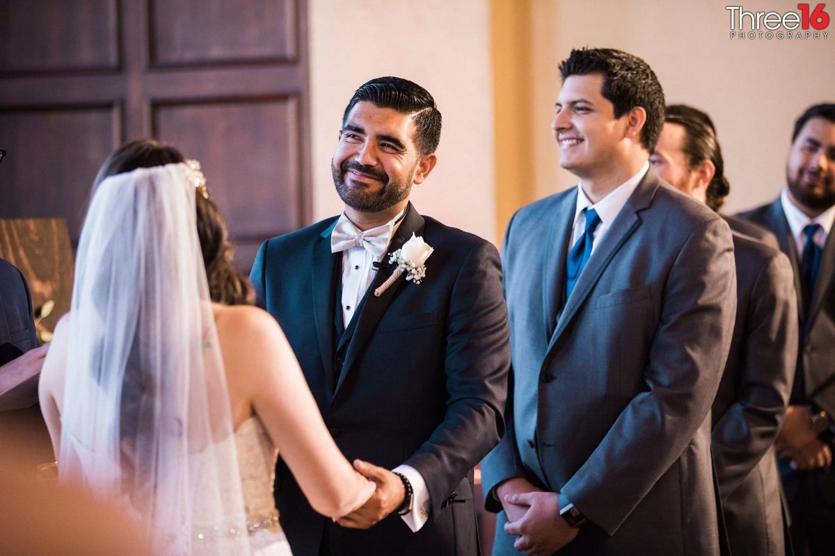 Groom faces his Bride as she take her vows