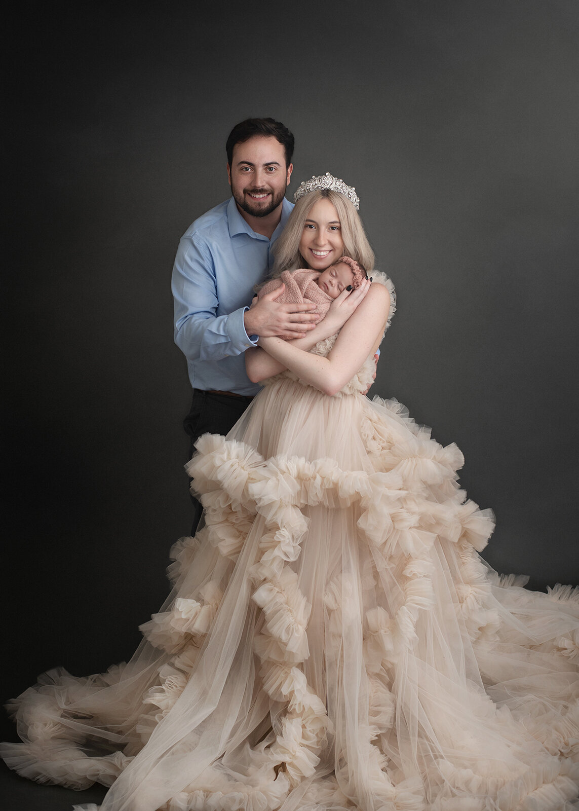 parents snuggling their newborn at photo session