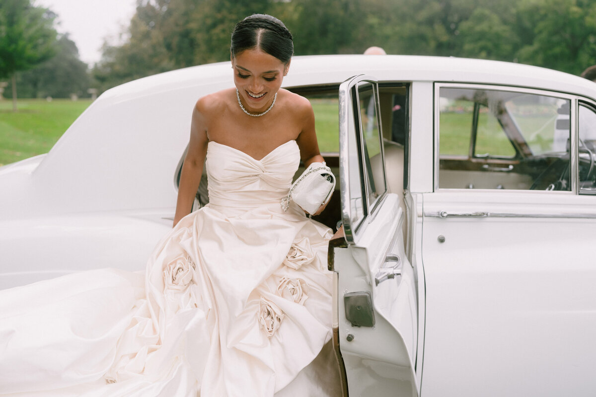 Bride stepping out of a Rolls Royce at her Rosecliff wedding at Newport Mansion