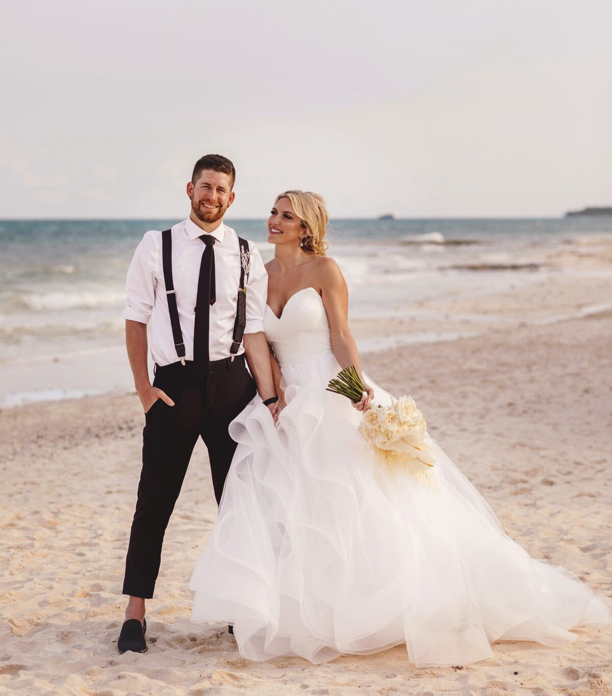 Editorial portrait of bride and groom on beach at  Iberostar Paraiso Riviera Maya Wedding