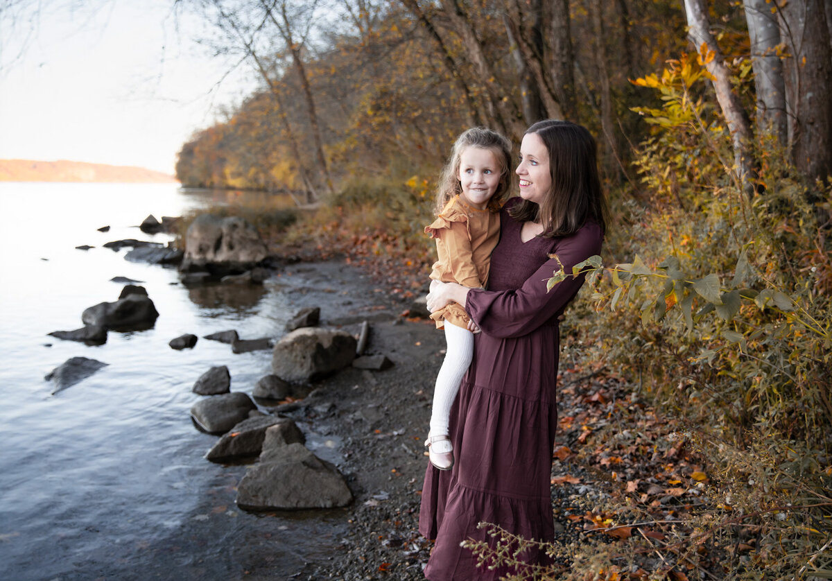 A Mother holds her daughter as they look out into the river in Harford County, Maryland