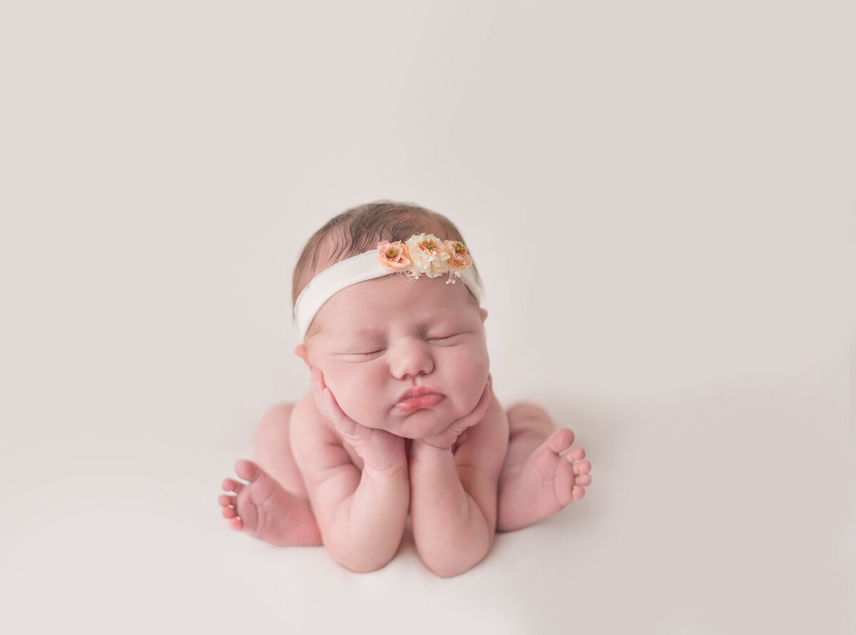 Adorable newborn in froggy pose photographed by Laura King Photography