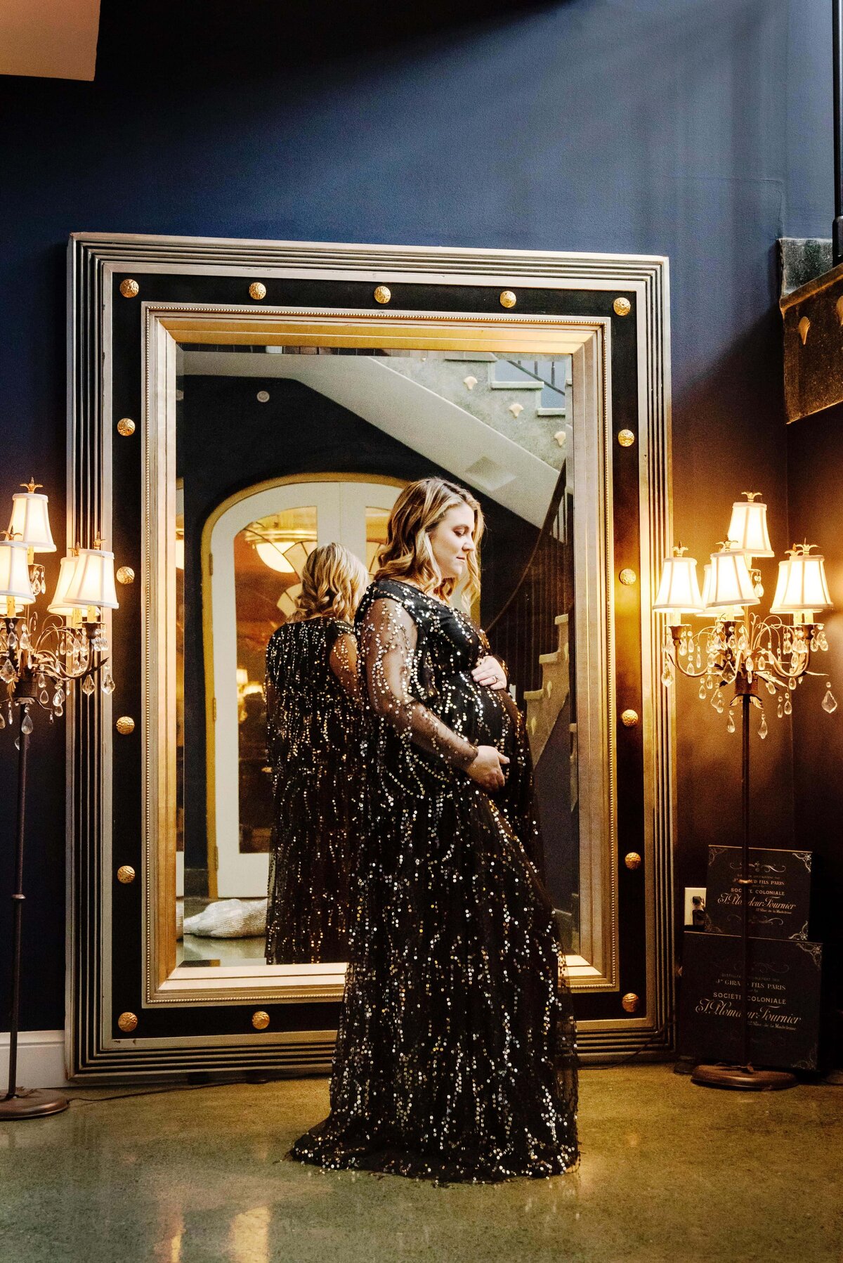st-louis-maternity-photographer-pregnant-mom-in-front-of-large-mirror-wearing-black-and-gold-sequin-gown
