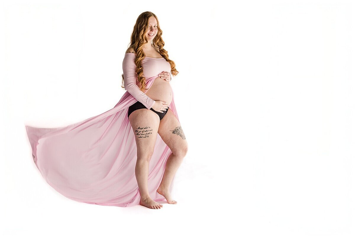 Mom is holding her baby belly during a studio Maternity Session in Wexford PA 