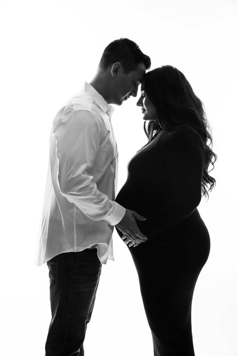 Expecting parents holding baby bump, taken by new jersey maternity photographer