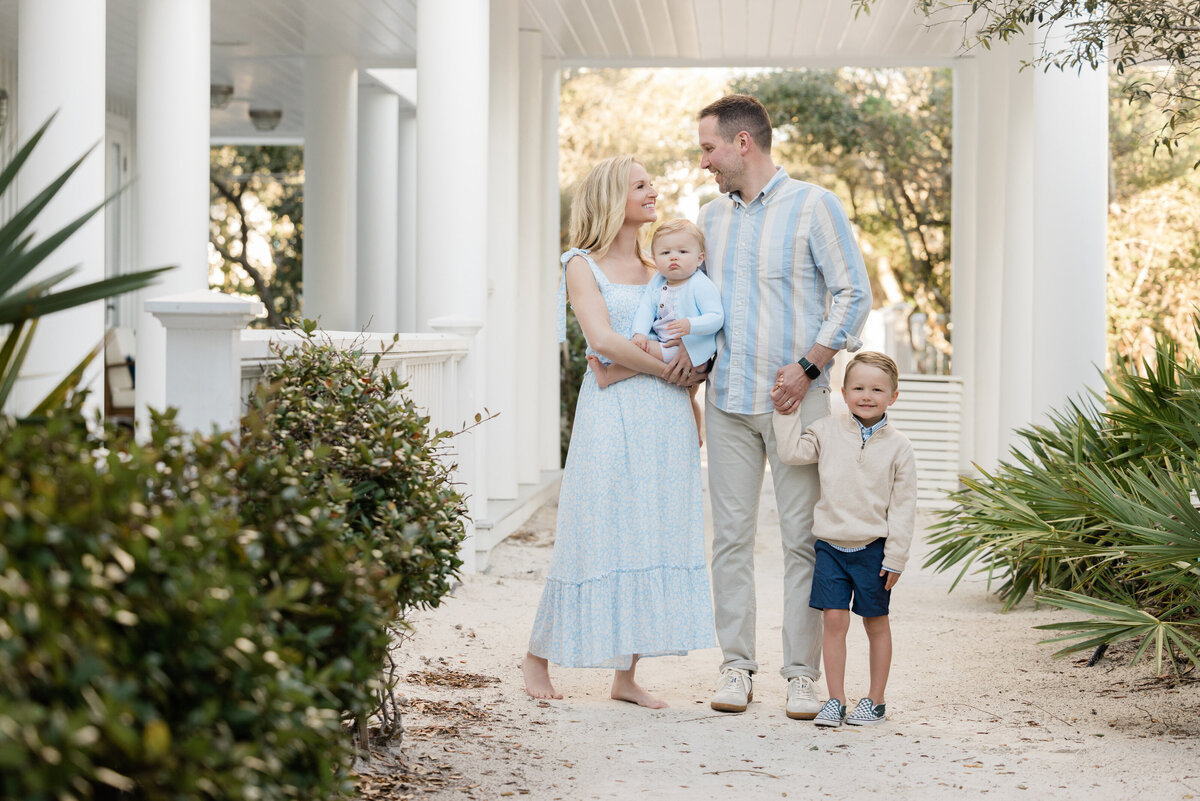 A family standing together under an awning smiling