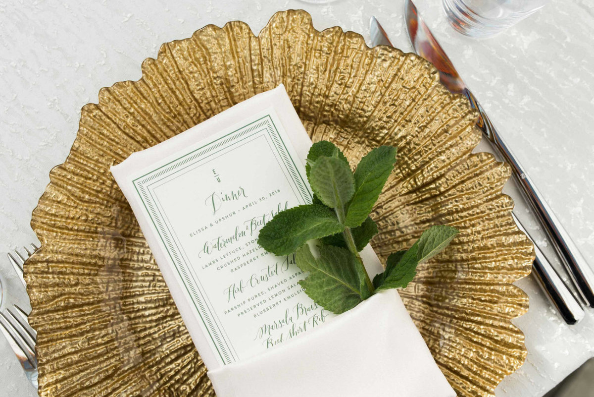 A sprig of fresh mint graces each place setting for a fresh green touch.