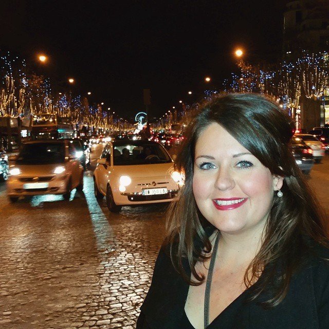 Jill Blue Photography poses on the Champs Elysees in Paris, France