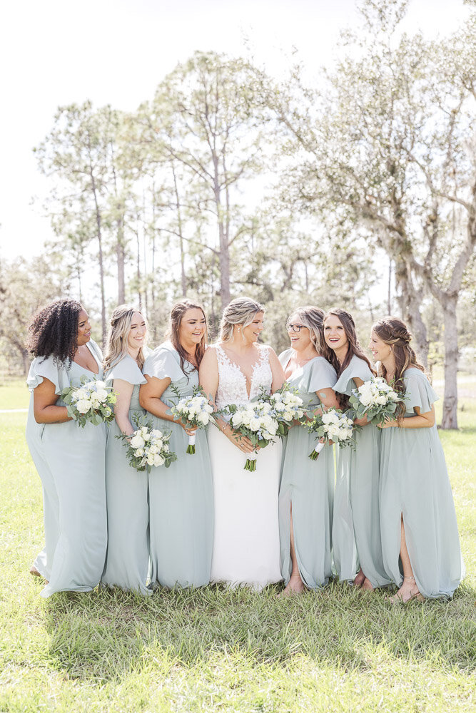 bride standing with bridesmaids on wedding day