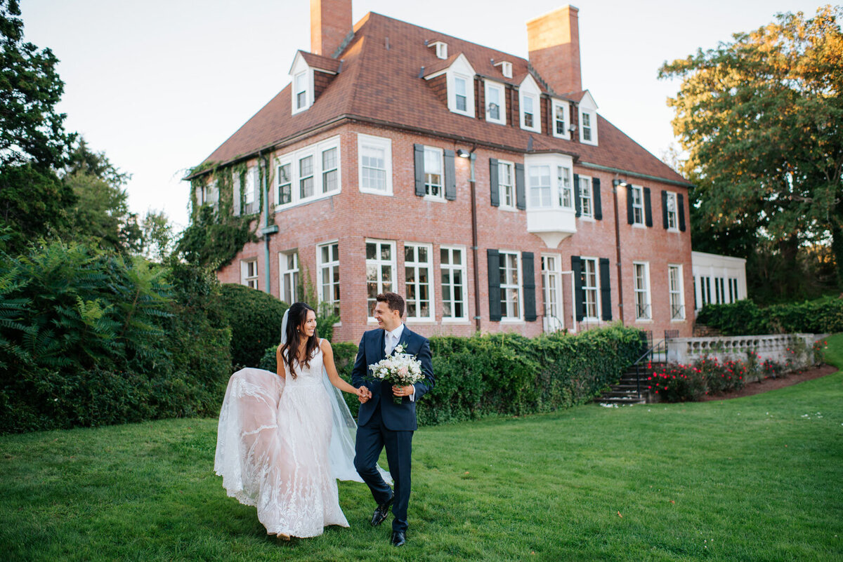 misselwood wedding at endicott college couple walking in front of mansion wedding