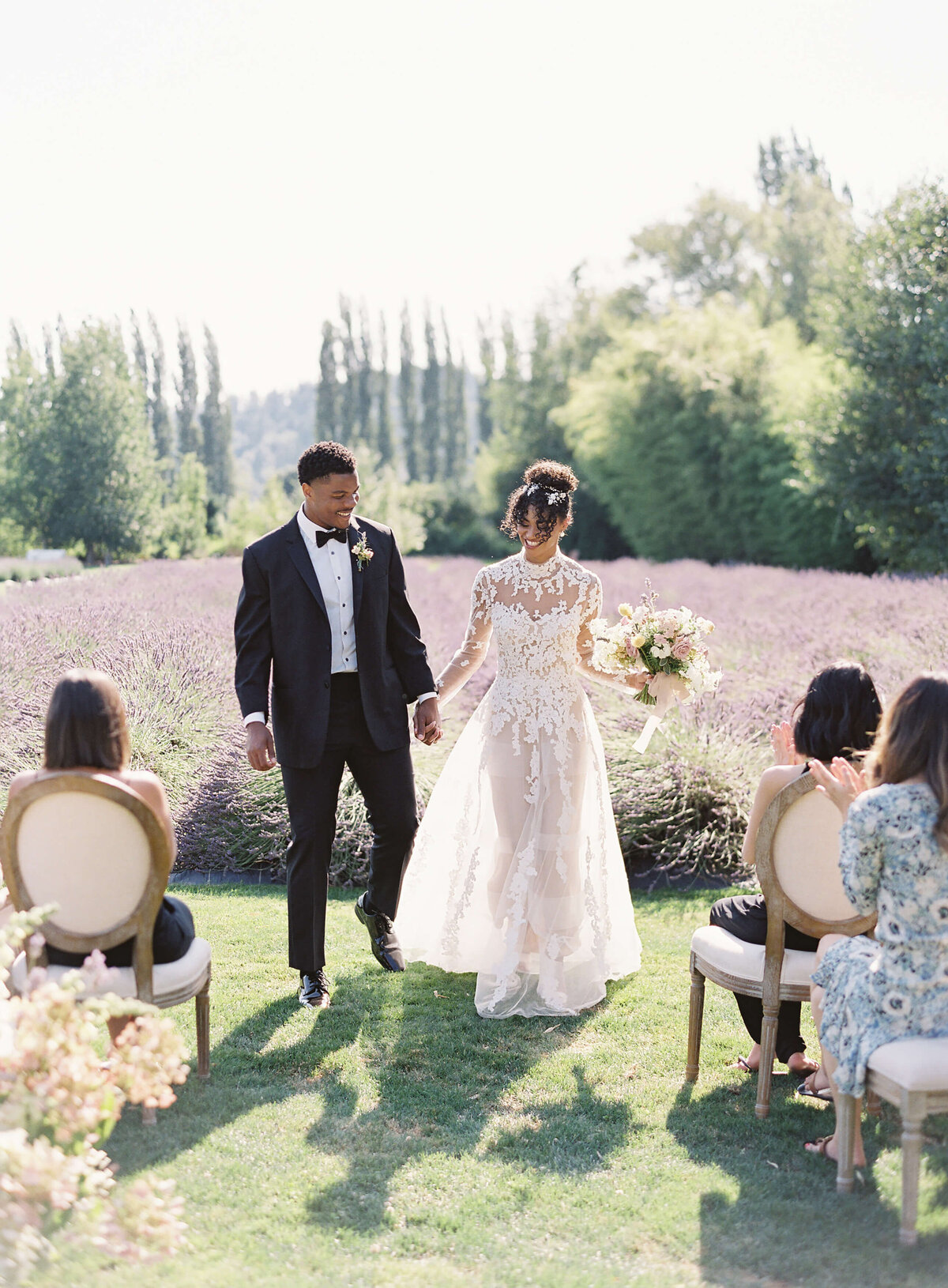 Bride and groom walk up the aisle at ceremony at Woodinville Lavender - Jacqueline Benét