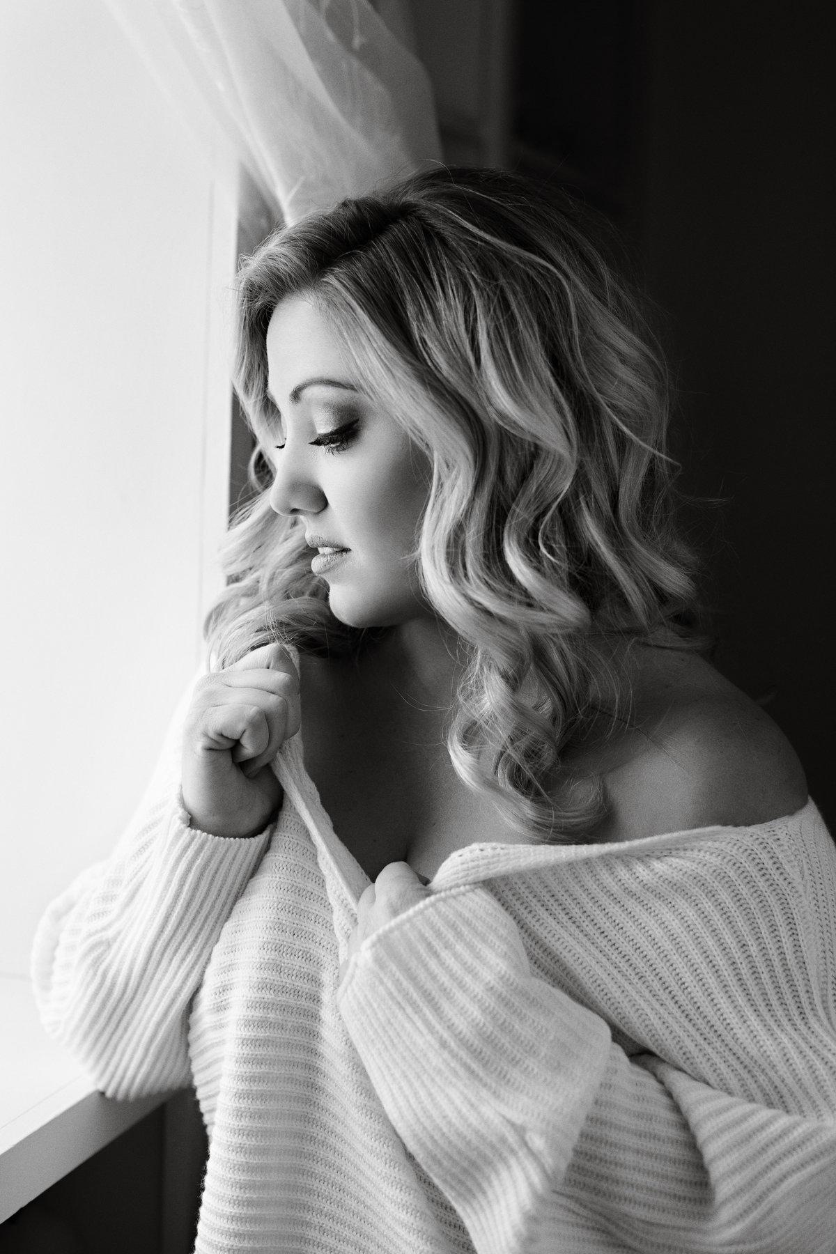Sexy black and white boudoir picture of woman in a oversized sweater