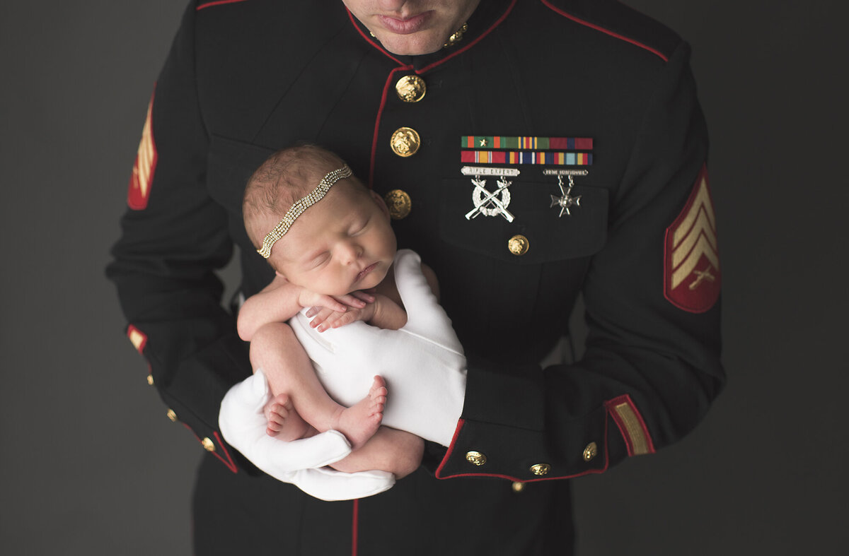 a military dad with his newborn baby