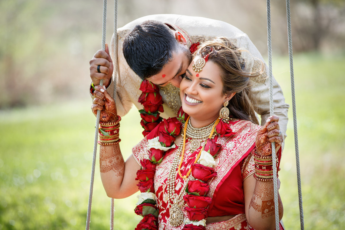 Indian wedding photographer pecan springs ranch bride groom swing natural light smiling happy colorful 10601 B Derecho Drive, Austin, TX 78737