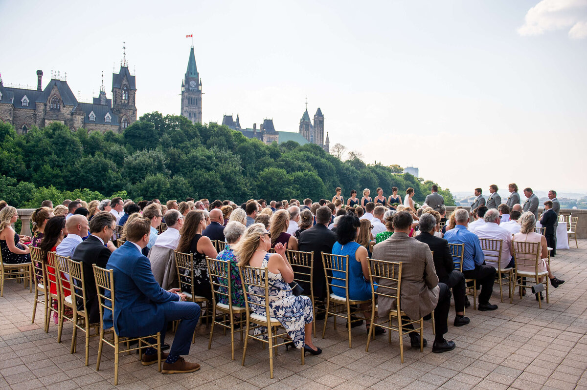 a ceremony photo that shows everyone who attended this Ottawa wedding on the Chateau Laurier terrace outdoors