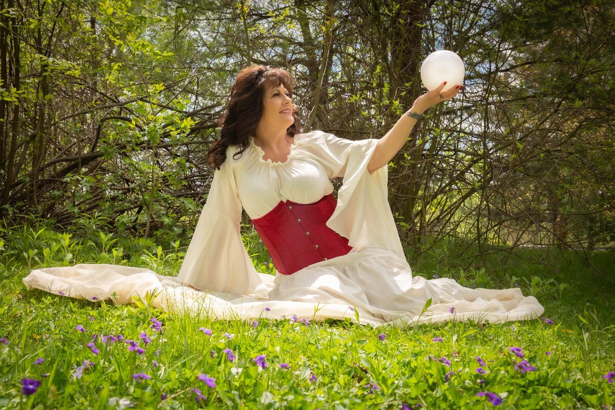 goddess studio boudoir red waist corset flowing white dress big sleeves magic crystal ball outside