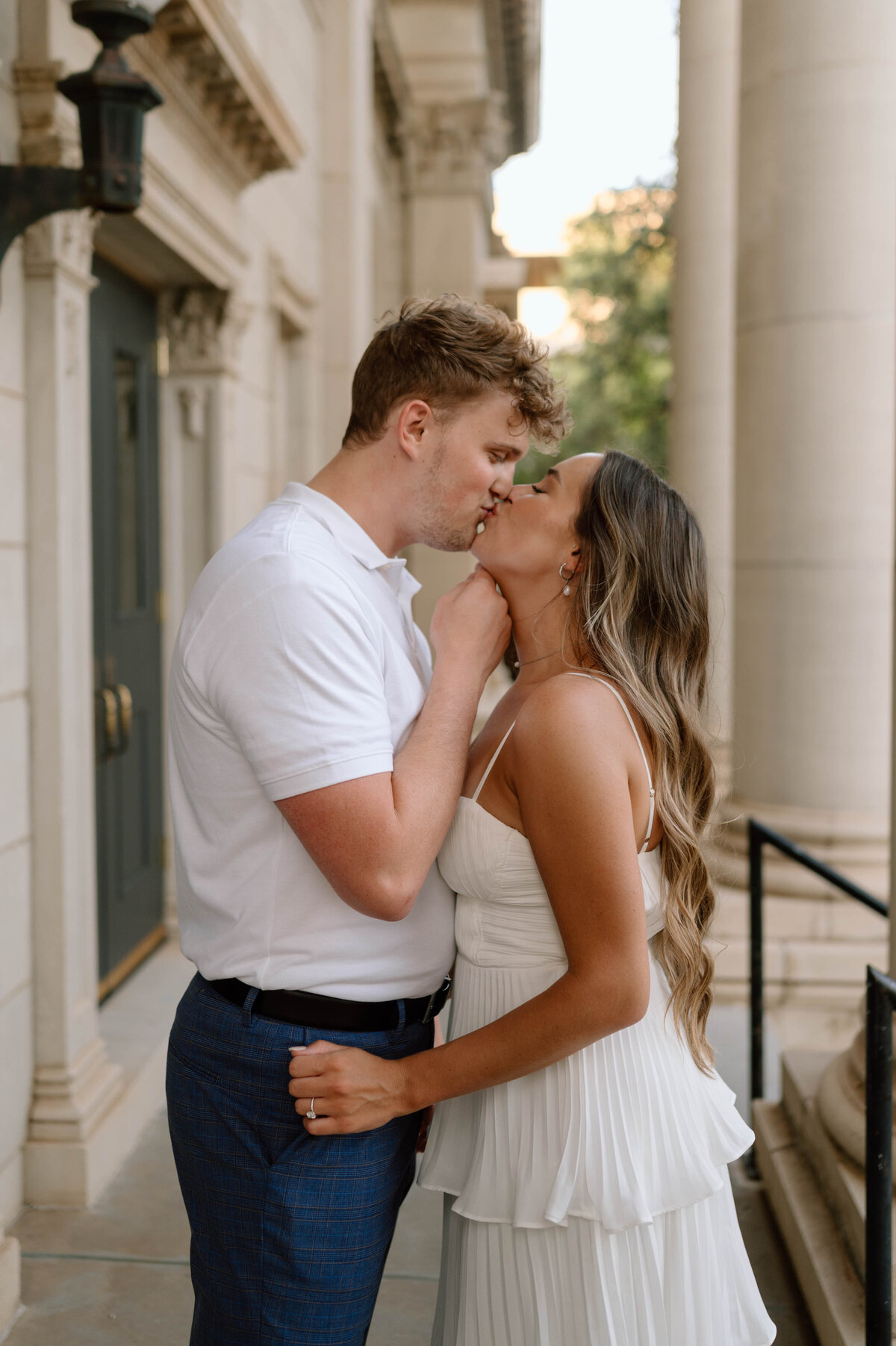 couple kissing during engagement photos in downtown oklahoma city