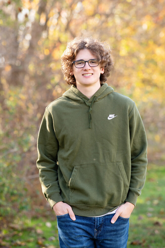 Senior session of young man in a green hoodie