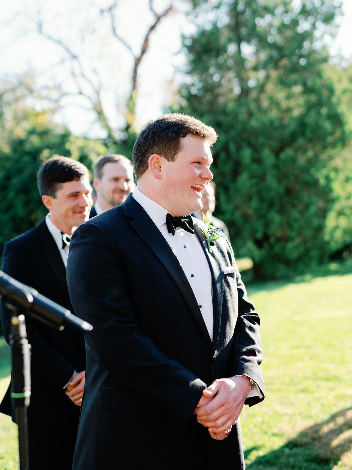 A groom looks as his bride makes it down the aisle for the first time