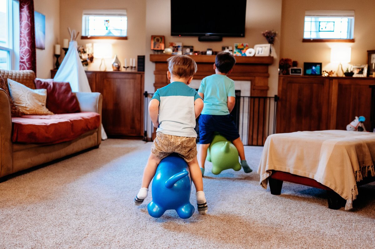 Brothers jumping in living room McKennaPattersonPhotography