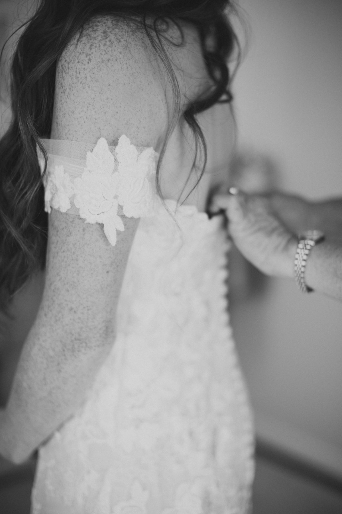 bride getting buttoned in dress on philadelphia wedding day