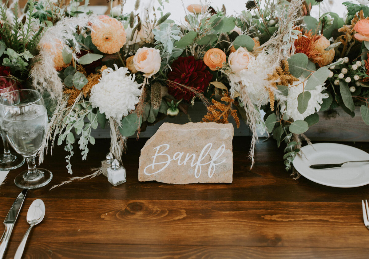 Stone table numbers with handwritten calligraphy for a mountain wedding in Steamboat Springs