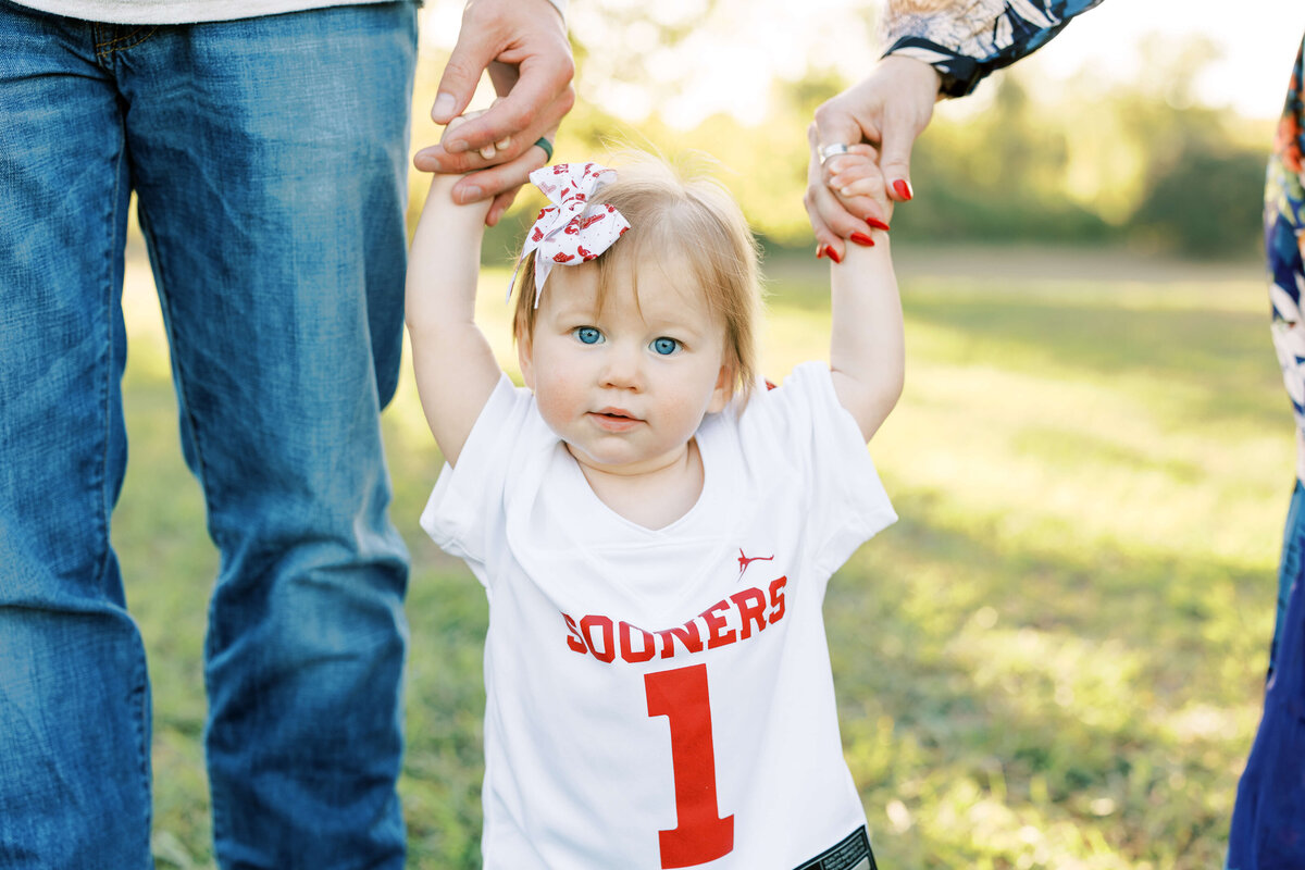 a little girl wearing a jersey with the number one on it