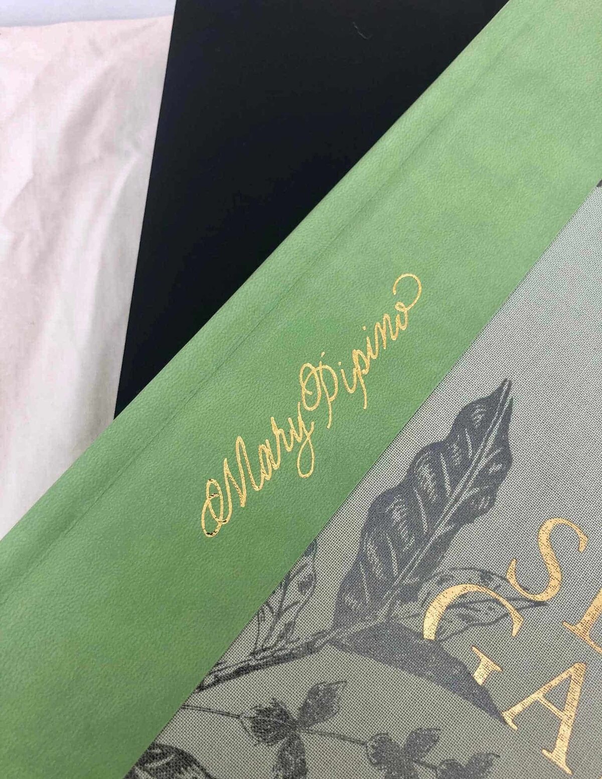 calligraphy name embossed in gold on a leather book cover