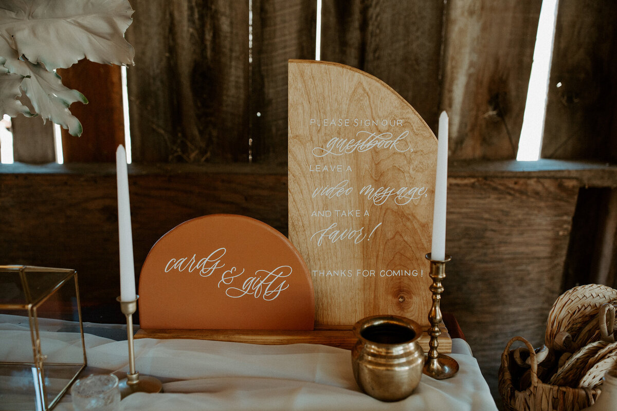 Welcome table display with arched wood signs