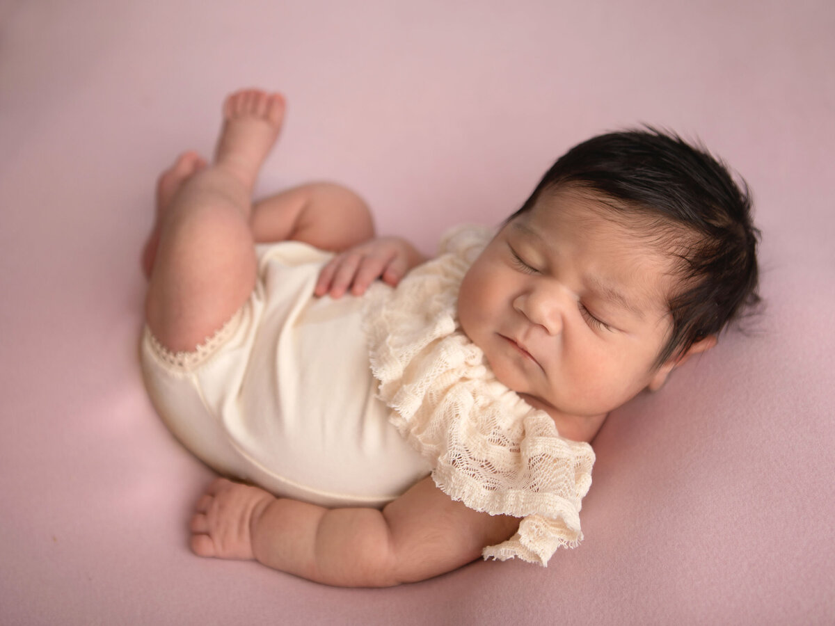 baby-girl-6-days-old-sleeping-for-her-newborn-photo-shoot
