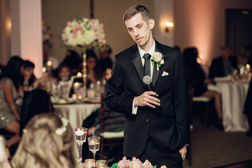 Wedding Photograph Of Groom In Black Suit Looking At a Visitor Los Angeles