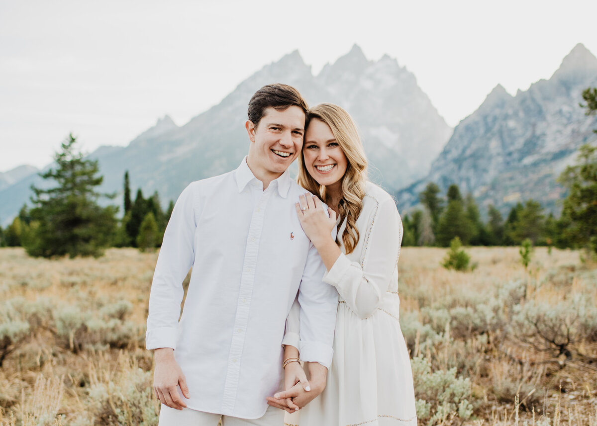 Photographers Jackson Hole capture couple wearing white outfits during engagements