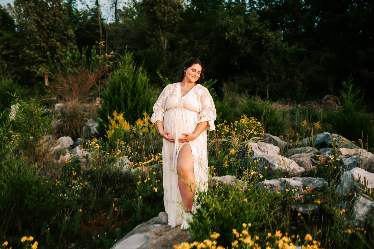 Springfield Mo maternity photographer Jessica Kennedy of The XO Photography captures pregnant mom standing on rock holding baby bump