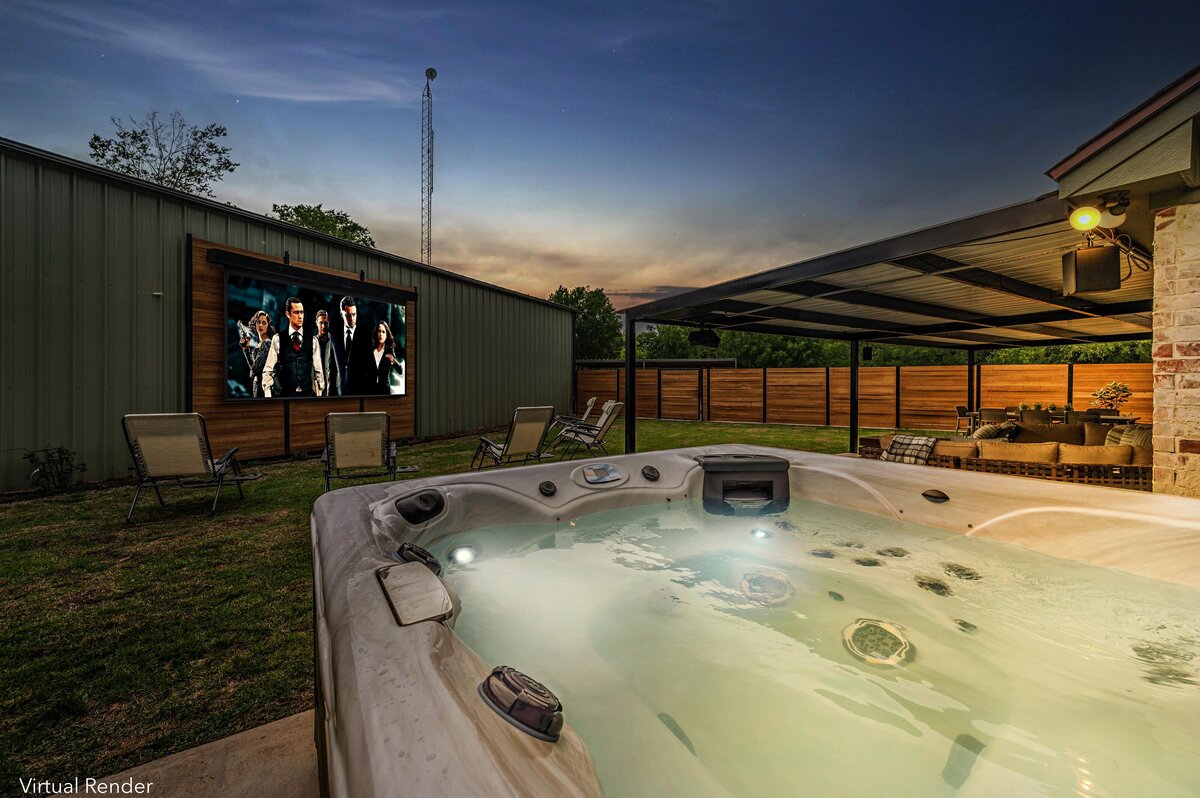 Backyard entertainment area with large hot tub and outdoor projector screen at this three-bedroom, three-bathroom vacation rental home with free wifi, outdoor theater, hot tub, propane grill and private yard in Waco, TX.