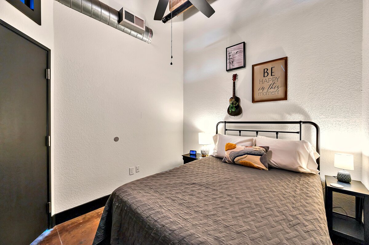 Bedroom in this two-bedroom, two-bathroom vacation rental condo in the historic Behrens building in the heart of the Magnolia Silo District in downtown Waco, TX.