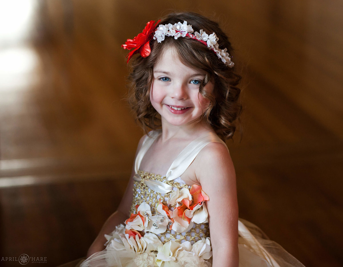 Sweet little flower girl wearing a flower crown at Manor House in Littleton Colorado