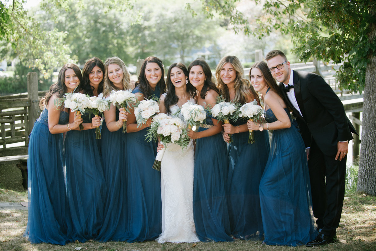 Bridal party with man of honor wearing blue dresses