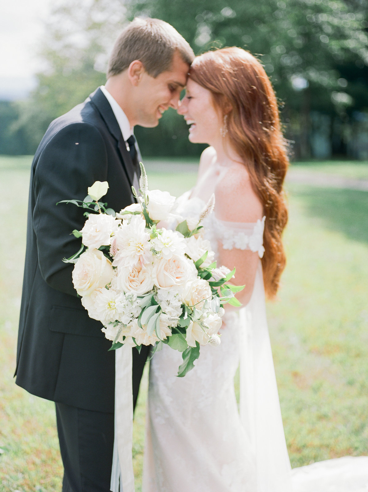 wedding couple nose-to-nose during outdoor portraits