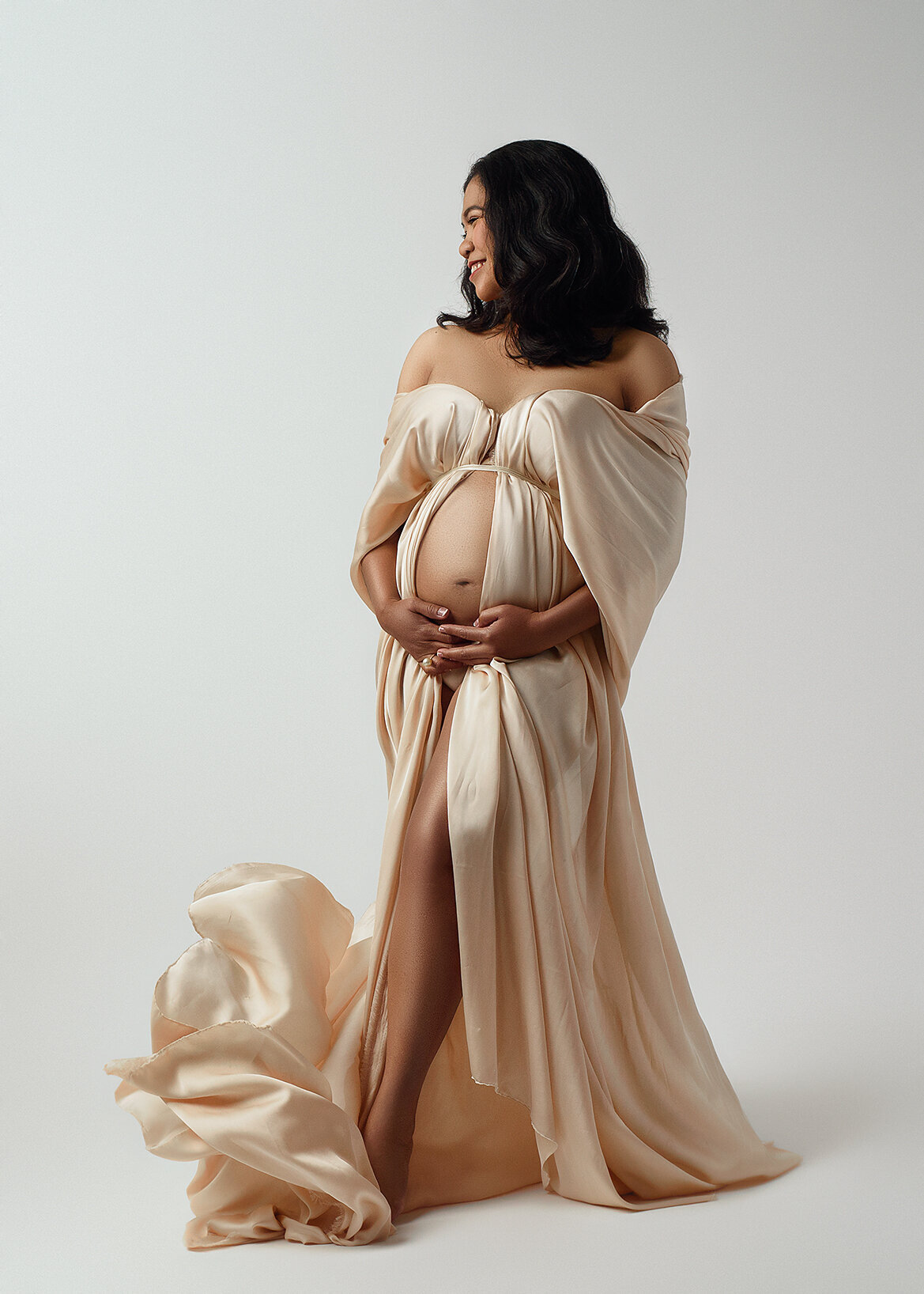 tan silk fabric flowing on beautiful maternity photoshoot mama in studio
