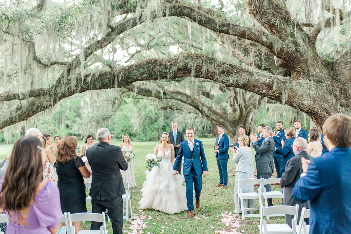 Couple walks down the aisle at the Magnolia Plantation and Gardens.