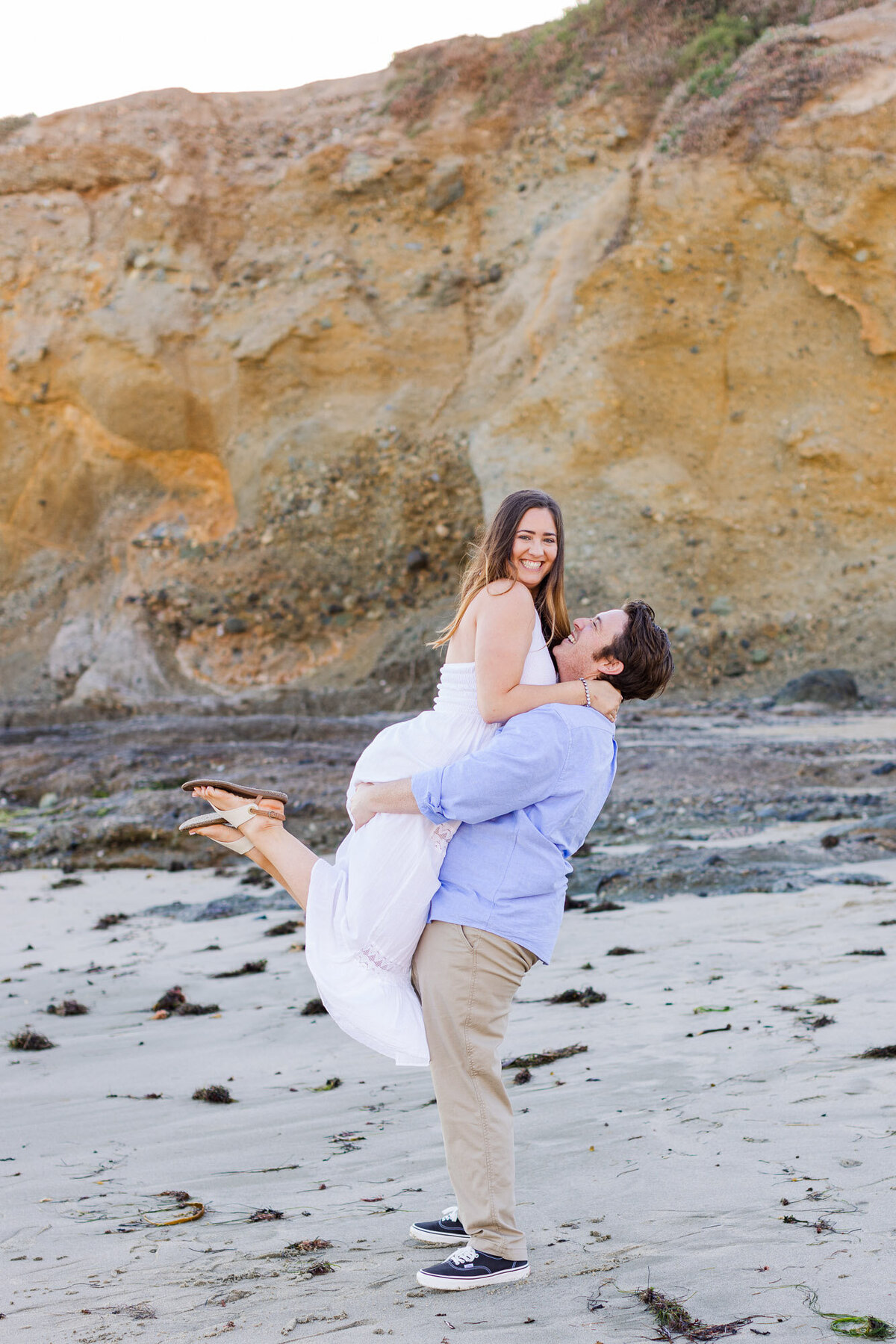 Laguna Beach CA engagement session at Montage Hotel colorful fun candid photo on epic beach by Joanna Monger Photography
